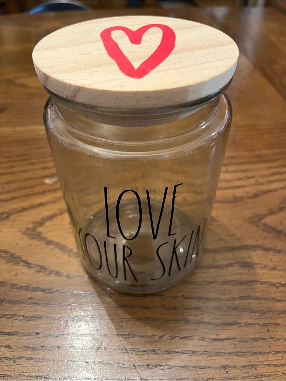 Rae Dunn storage jar featuring "LOVE YOUR SKIN writing and Wooden Lid